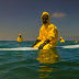 Activist Surfs In Hazmat Suit To Depict The Possible Future Of Oceans